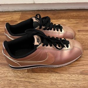 Nike rose gold and black Cortez’s worn a hand full of times